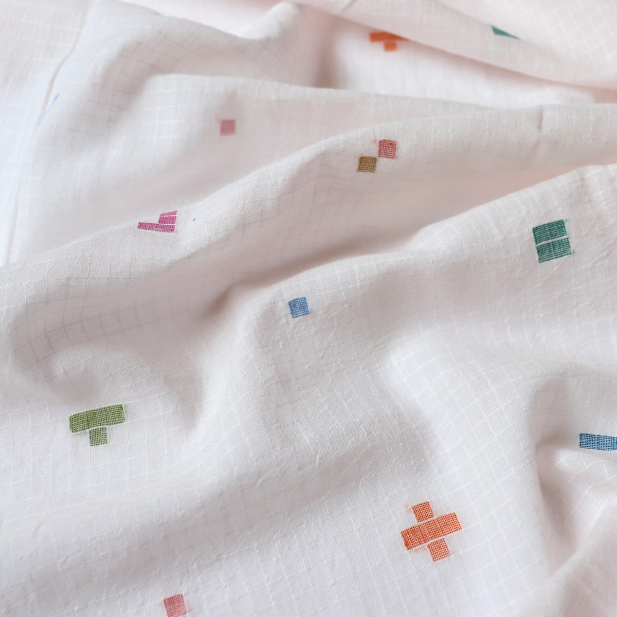 pink jamdani cotton fabric with colorful geometric weave