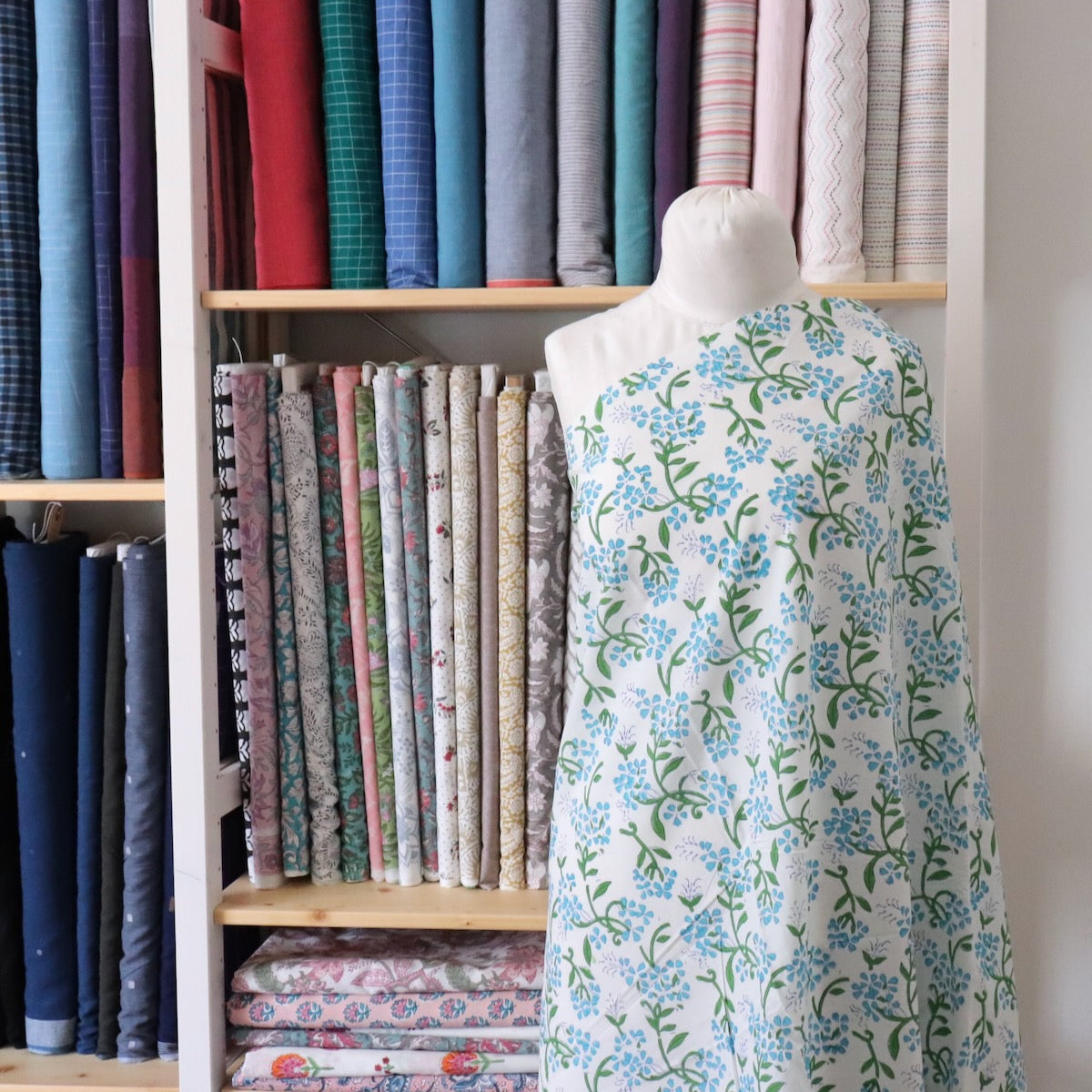 bright blue floral print cotton fabric with green leaves hand made in India
