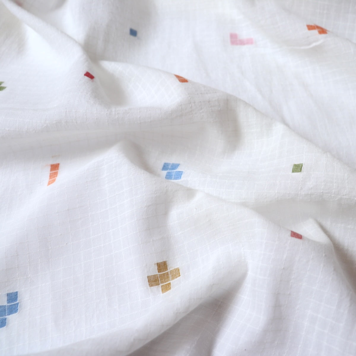 white jamdani cotton fabric with colorful geometric weave