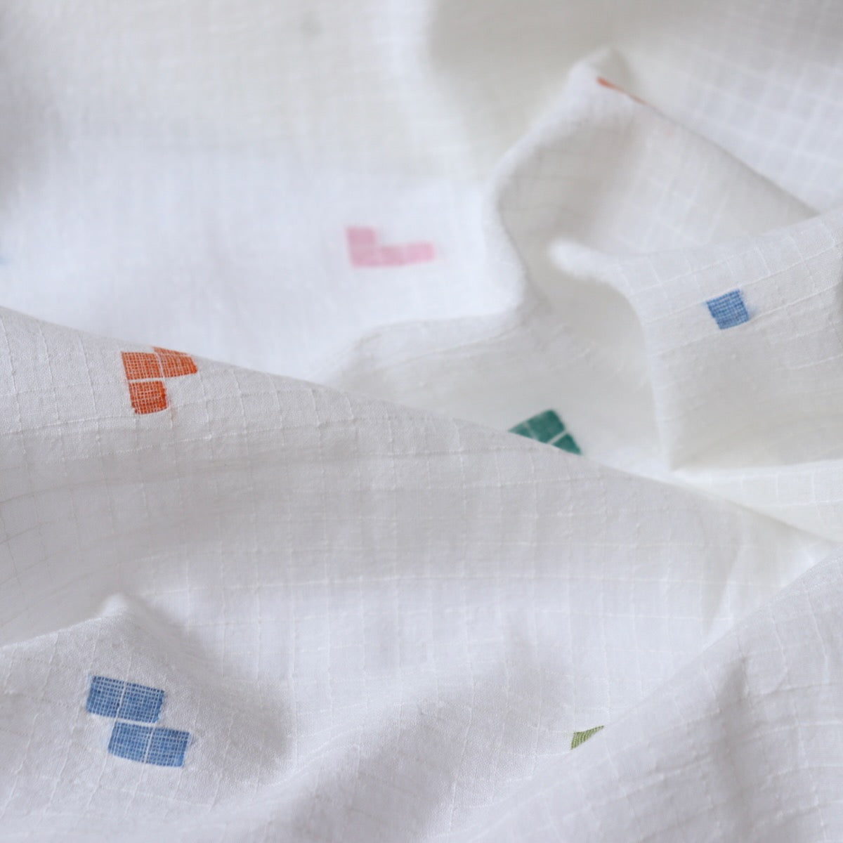 white jamdani cotton fabric with colorful geometric weave