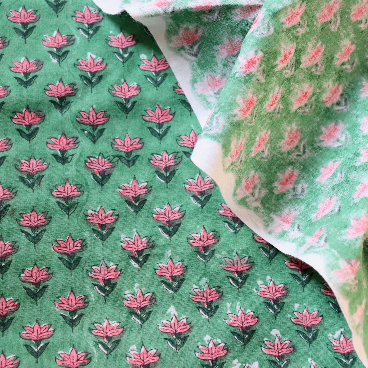 tiny pink floral hand block print fabric on bright green cotton