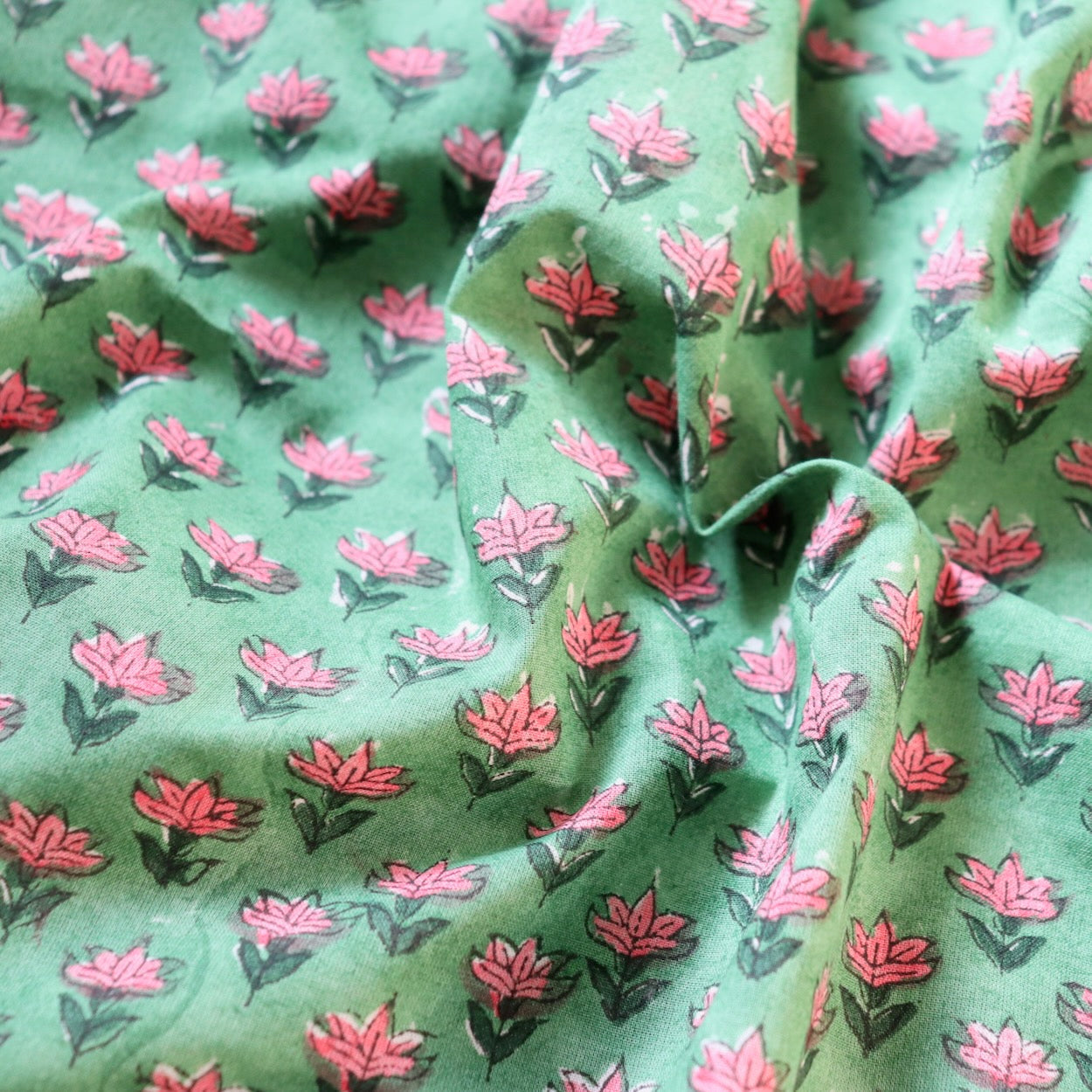 tiny pink floral hand block print fabric on bright green cotton
