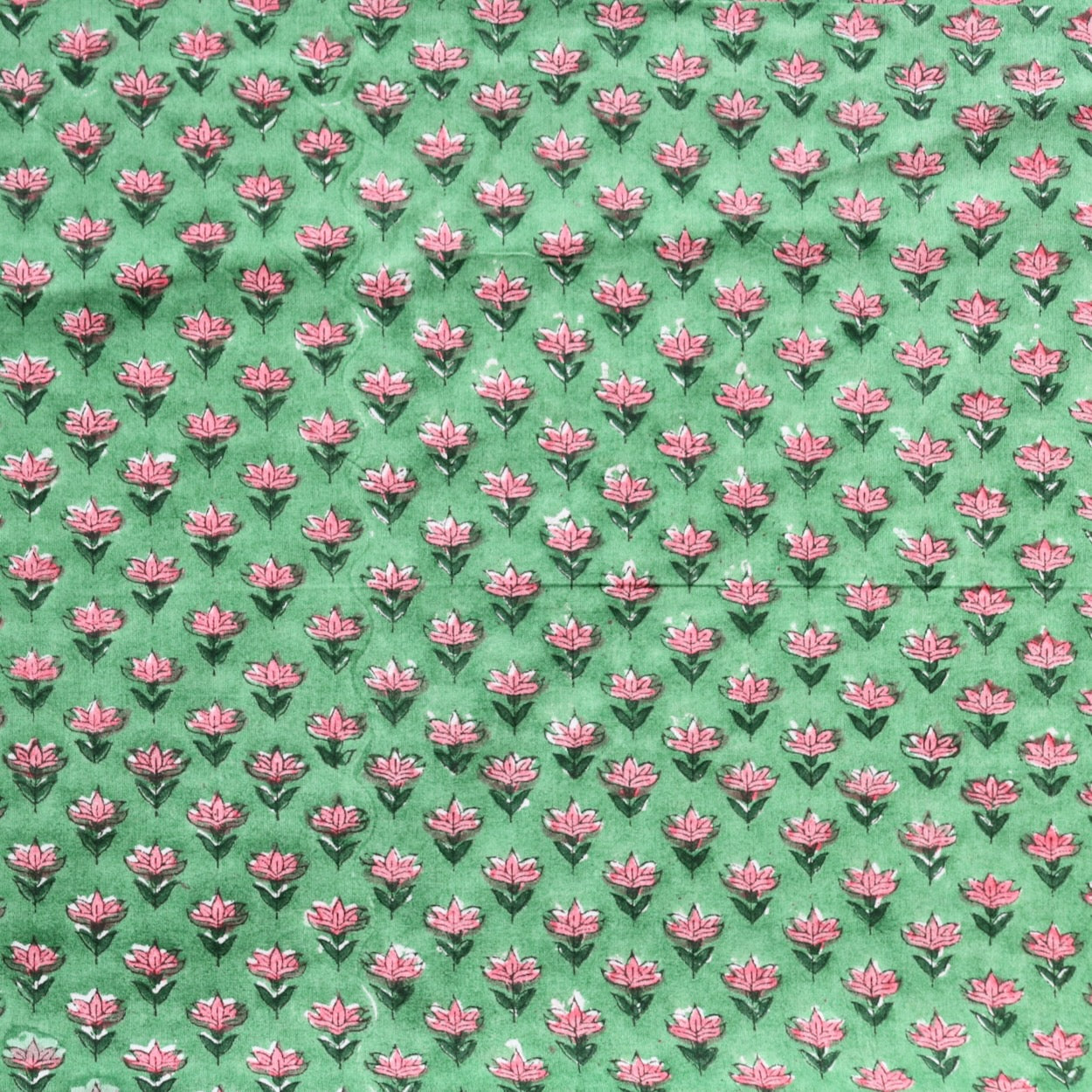 tiny pink floral hand block print fabric on bright green cotton