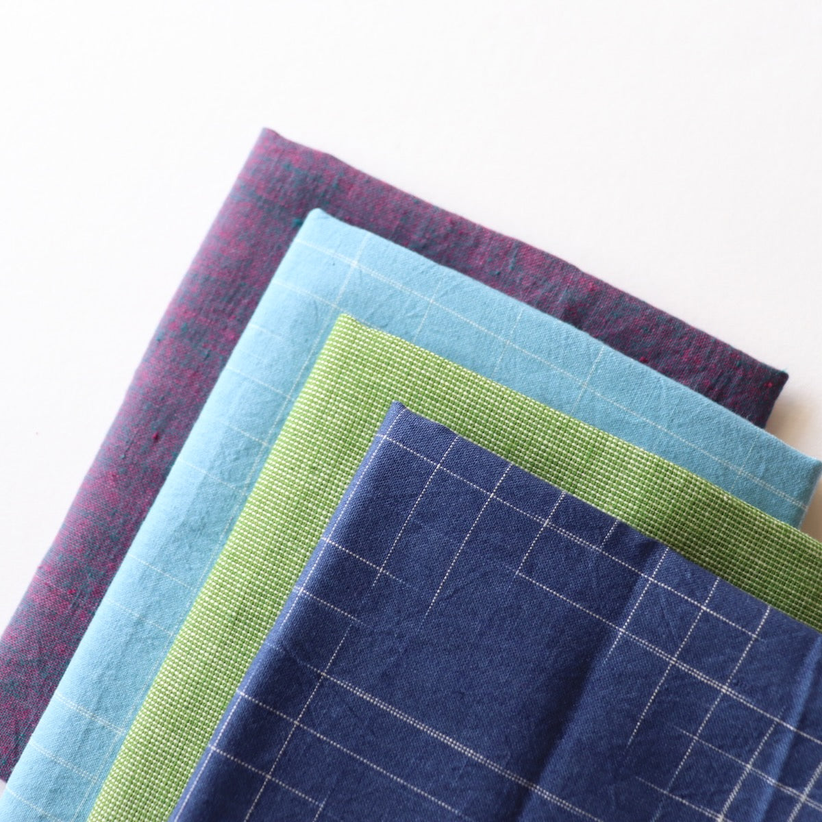 curated bundle of handwoven cotton fabrics in cool blues purple and green quilting fabric