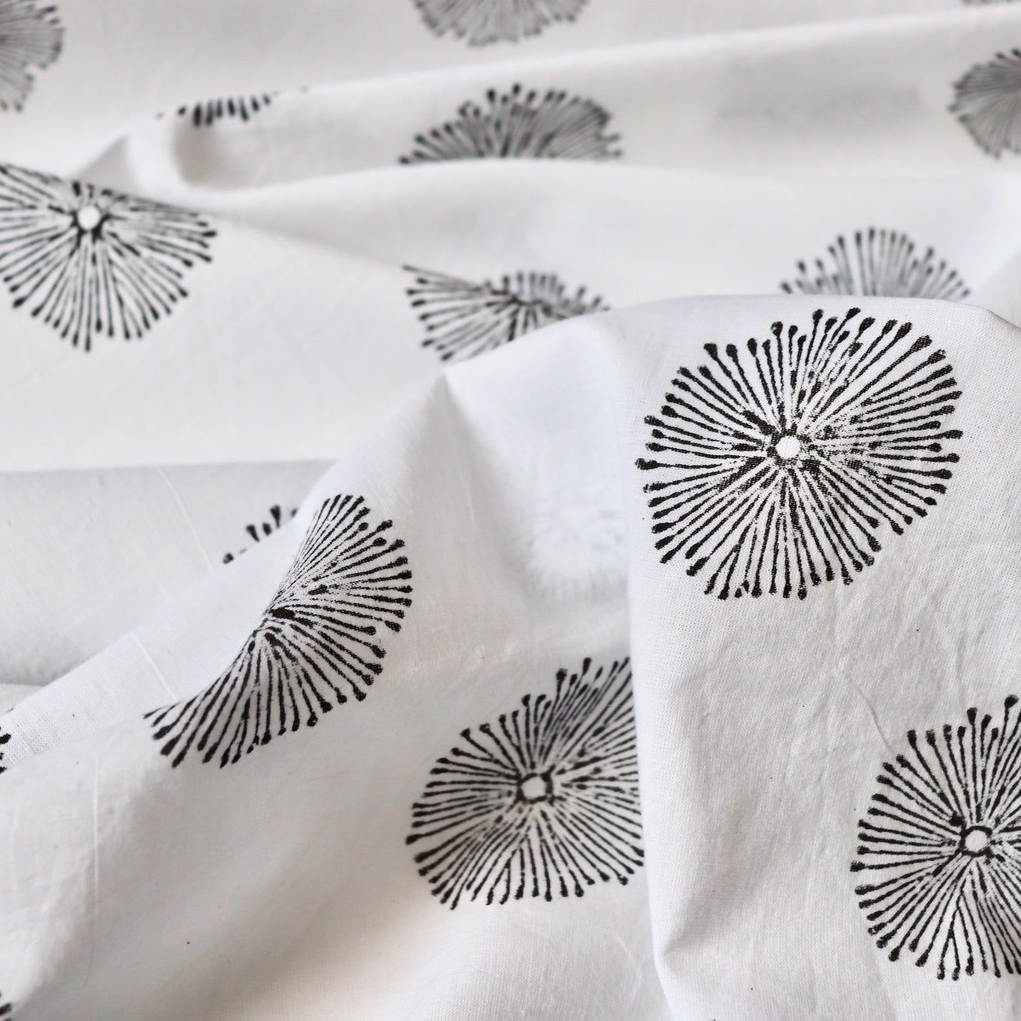 white cotton fabric with hand printed black flowers made in India