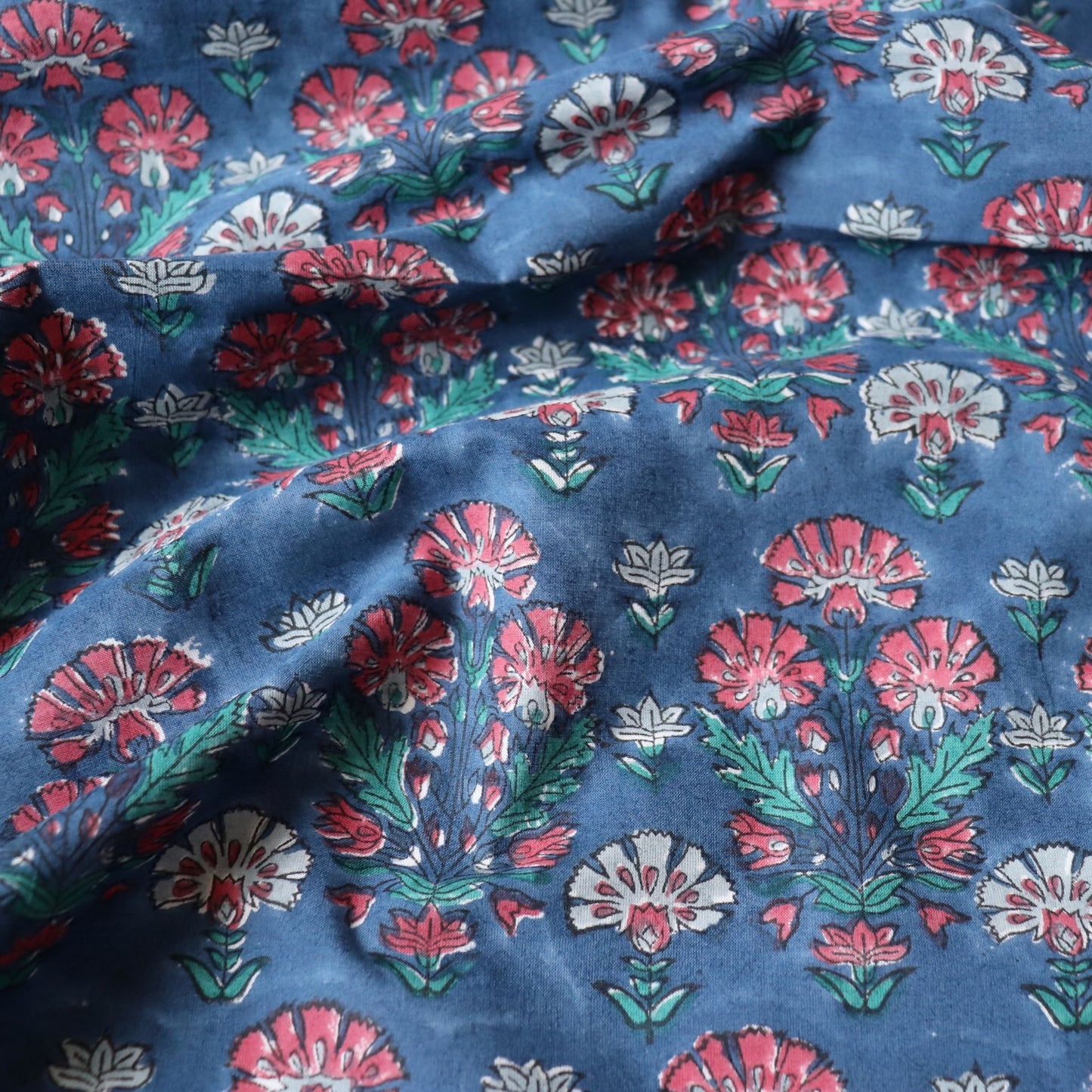 dark blue block printed cotton fabric with red flowers for quilting and dressmaking
