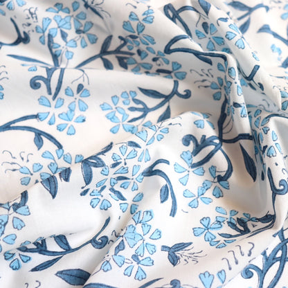 blue and white delicate floral hand block print white cotton dressmaking and quilting fabric