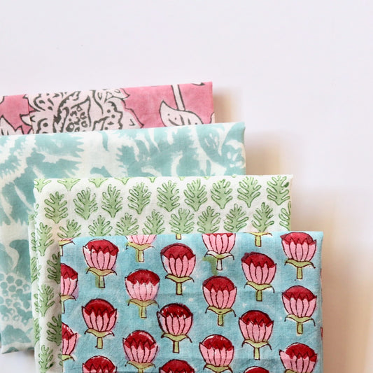 bundle of hand print cotton fabrics in bright pastel colors for quilting and crafts