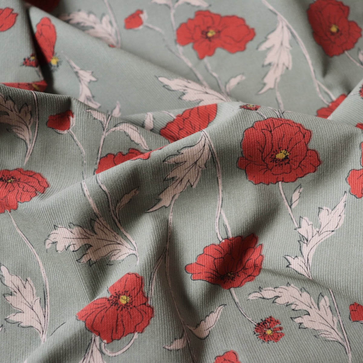 hokkoh poppies fabric cotton pinwale cord green and red-orange floral 