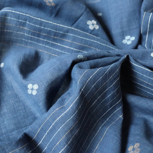 natural indigo blue cotton fabric handwoven with dots and stripes for dressmaking and sustainable fashion