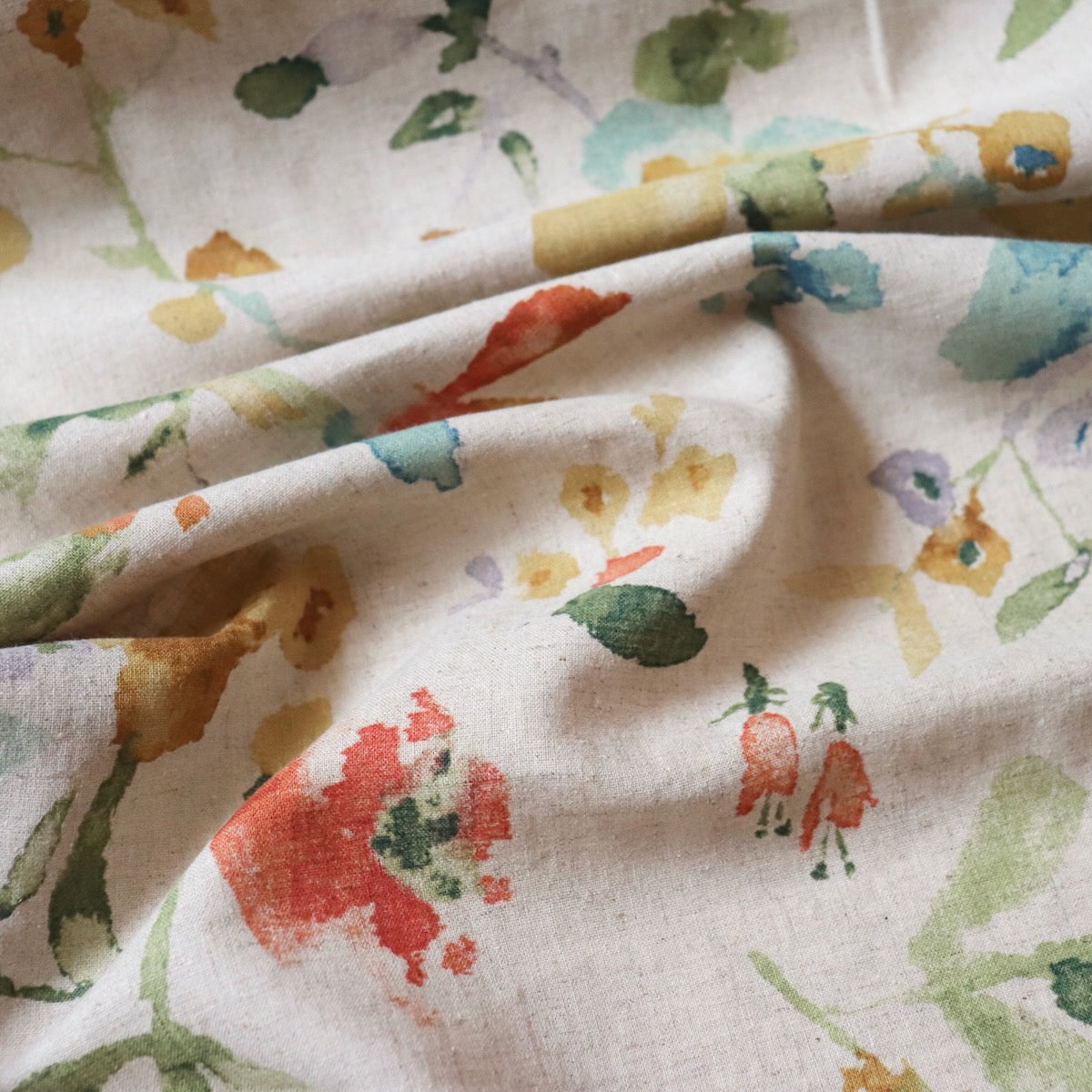flax-color linen cotton fabric from Japan with colorful watercolor-style floral print 