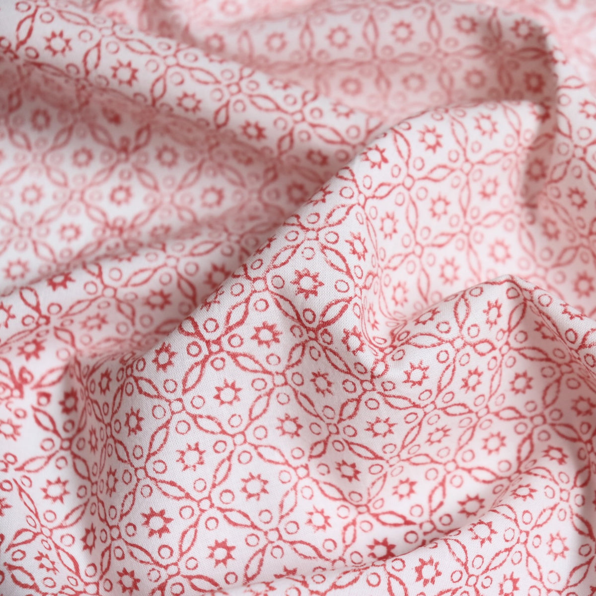 warm red floral design on white cotton fabric hand printed in India for historic costuming and quilting