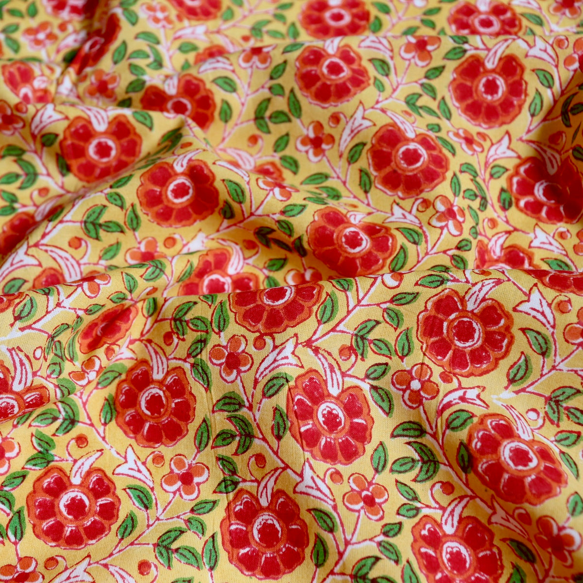 bright yellow and red floral design hand printed cotton fabric made in India