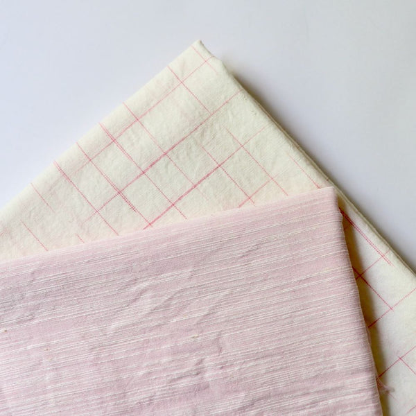 two pink and white handloom cotton fabrics